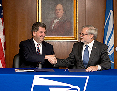 Postmaster General Patrick Donahoe and APWU President Cliff Guffey sign the union's 2010-2015 Collective bargaining Agreement with the Postal Service. 