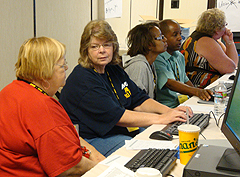 APWU retirees work together in the hands-on technology workshop to increase their computer skills.