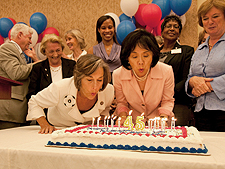 Congresswomen Jan Schakowsky (D-IL) and Judy Chu (D-CA) blow out birthday candles for Medicare and Medicaid.
