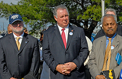 (Left to right) Jersey City Mayor Jerramiah T. Healy, and U.S. Reps. Albio Sires and Donald Payne listen to a union speaker denounce USPS plans to privatize the Jersey International Bulk Mail Center.