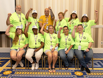 Committee on Political Action Captain Committee Members Pose for a Photo with Fists Raised