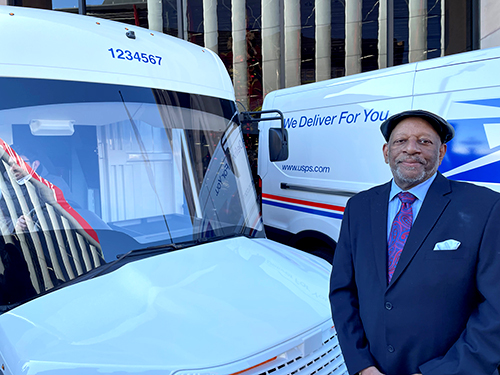 Motor Vehicle Services (MVS) Director Michael Foster beside a new USPS Electric Truck
