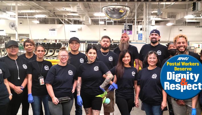 postal workers stand in a group in a postal facility