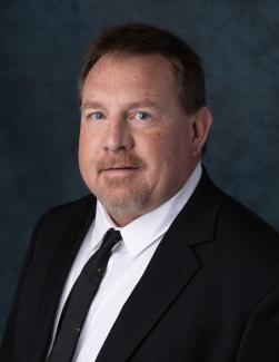 Headshot of APWU National Business Agent Gregory Becker