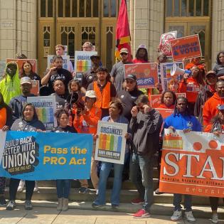 a group of union members rally in front of the Georgia state capitol building in Atlanta