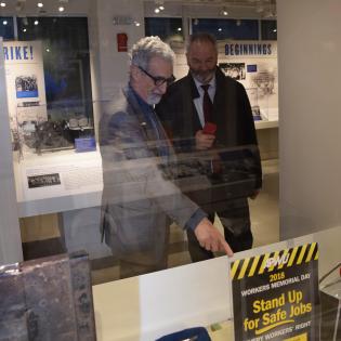 APWU President Mark Dimondstein shows a guest a display at the History Center