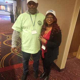 Two APWU members wearing COPA hats